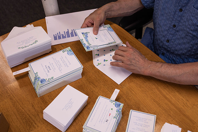 Bob assembling wedding invitations